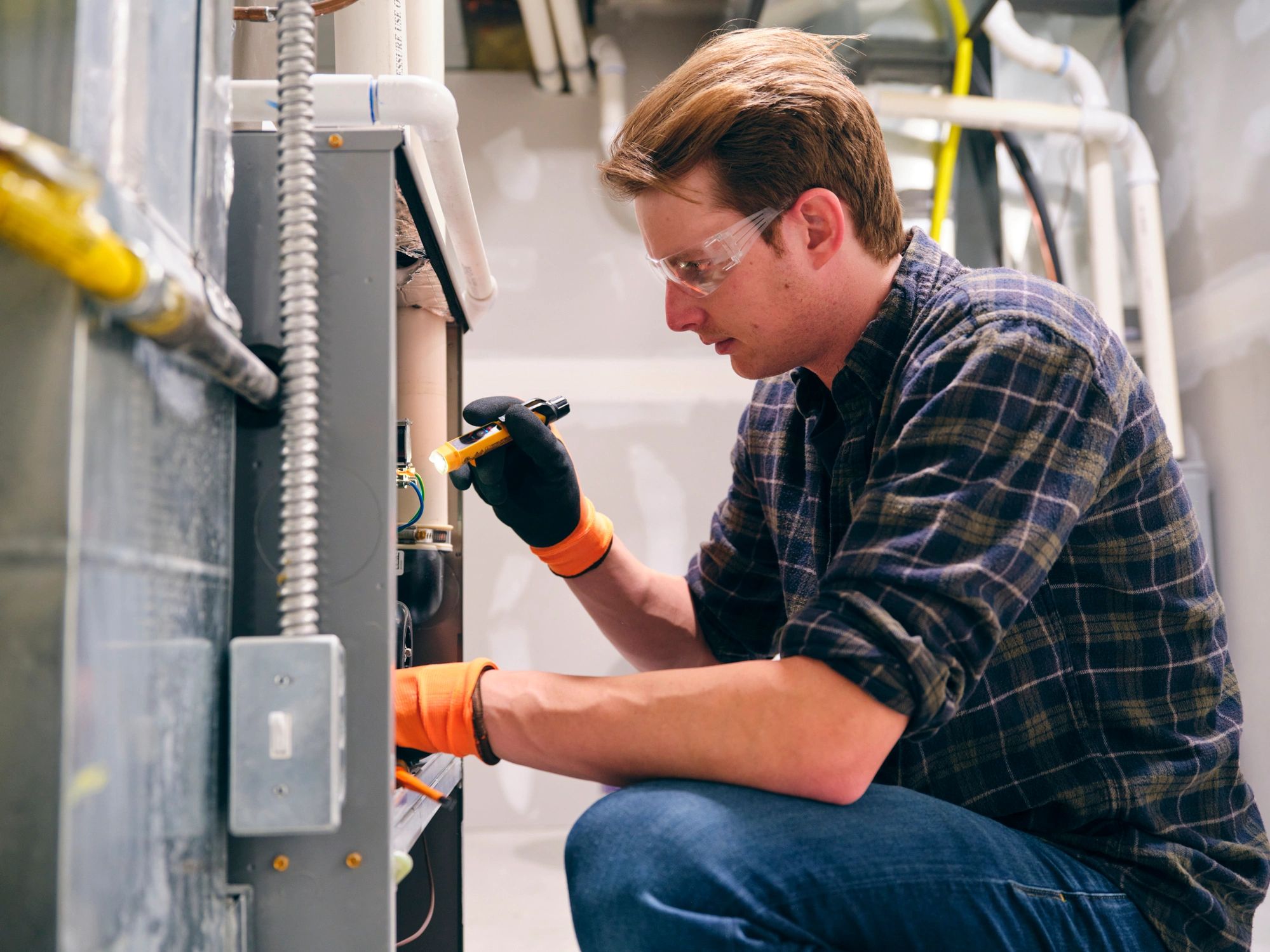 HVAC technician servicing a home furnace
