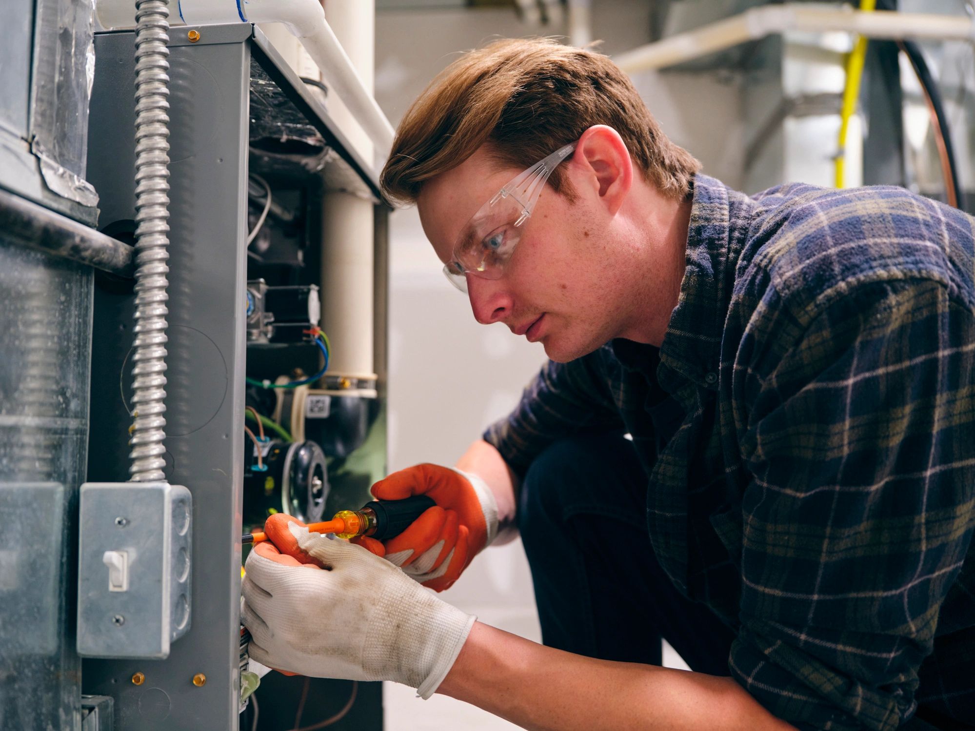 Technician servicing a residential furnace