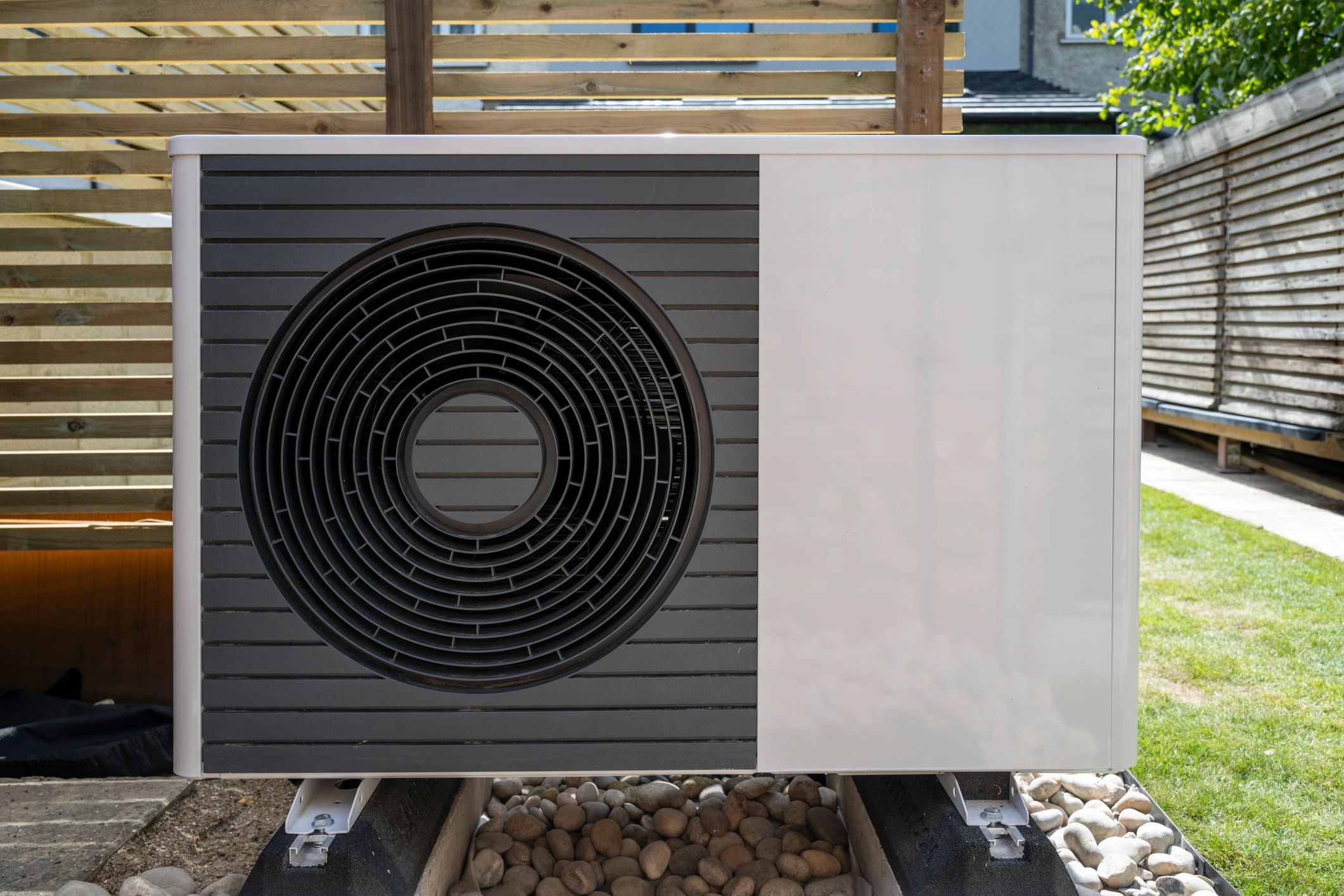 Outdoor air conditioner or heat pump unit beside a home